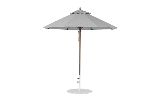 The Ledge Lounger Essential Fiberglass Umbrella features a 7.5 octagonal canopy made from marine-grade fabrics for durability, atop a slender fiberglass pole with a circular base, ideal for garden or patio settings and wind resistance.