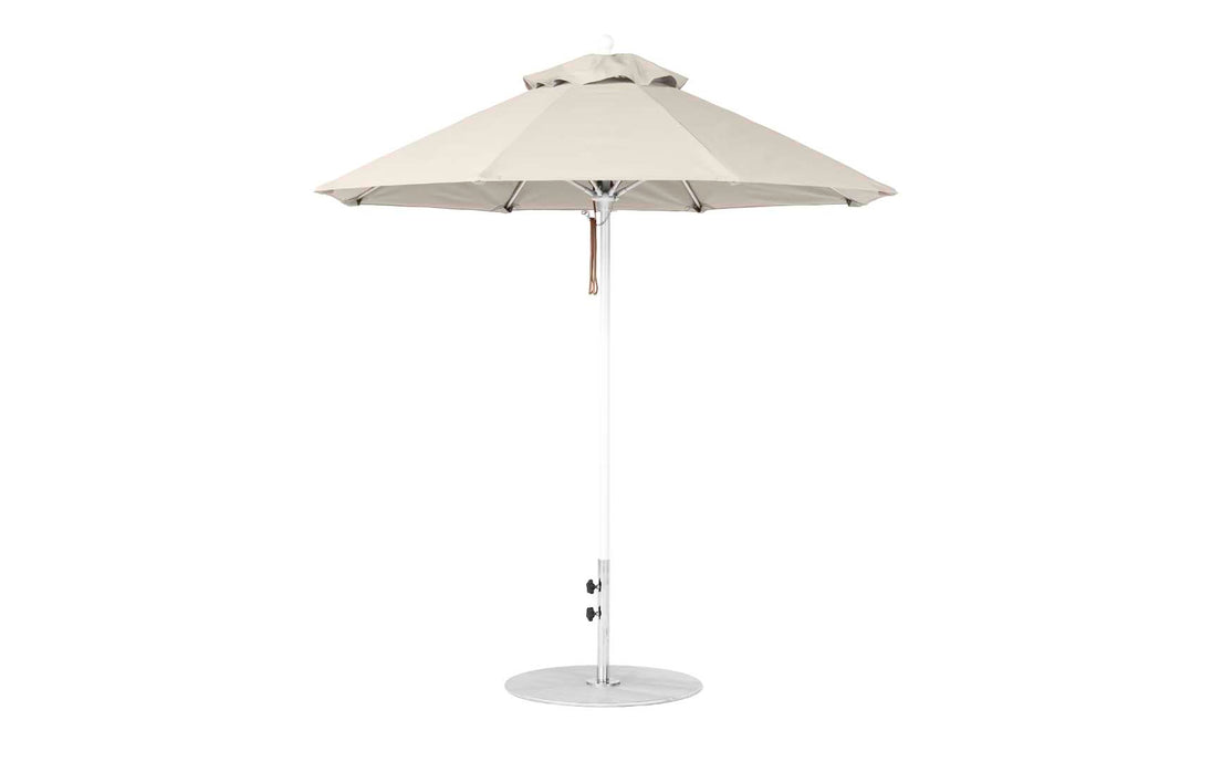 The Ledge Lounger Essential Fiberglass Umbrella features a 7.5 octagon canopy in beige, made from marine-grade fabric with wind-resistant properties and a sturdy metal pole. It includes a crank for angle adjustments and stands on a circular base.