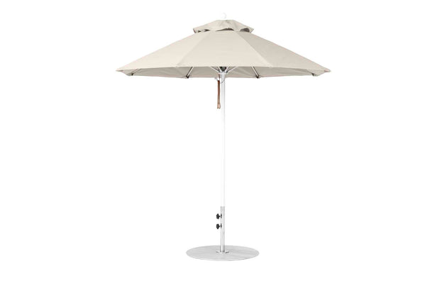 The Ledge Lounger Essential Fiberglass Umbrella features a 7.5 octagon canopy in beige, made from marine-grade fabric with wind-resistant properties and a sturdy metal pole. It includes a crank for angle adjustments and stands on a circular base.