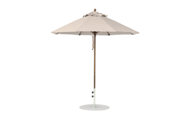 The Ledge Lounger Essential Fiberglass Umbrella features a beige octagon canopy with a straight pole on a circular weighted base. Crafted from wind-resistant, marine-grade fabrics, this 7.5 umbrella offers optimal outdoor shade when fully open.