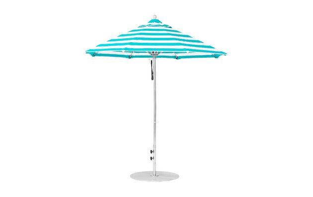 The Ledge Lounger Essential Fiberglass Umbrella features a striped turquoise and white design with a pointed top, supported by a wind-resistant metal pole made from marine-grade fabrics. Standing upright on a round base, this 7.5 octagon pulley umbrella is both stylish and durable.