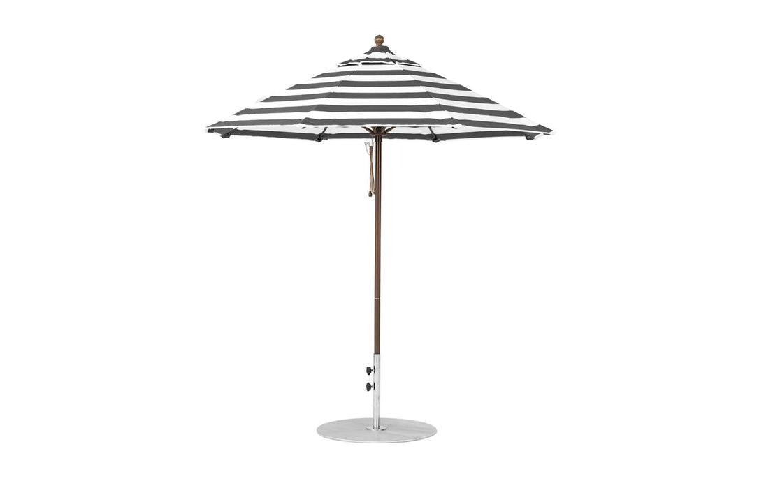 The Essential Fiberglass Umbrella by Ledge Lounger features black and white stripes, a wind-resistant marine-grade fabric, an octagonal shape with a central pole and round base. The 7.5 outdoor umbrella is open against a plain white background.