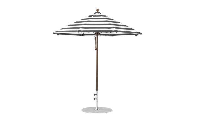 The Essential Fiberglass Umbrella by Ledge Lounger features black and white stripes, a wind-resistant marine-grade fabric, an octagonal shape with a central pole and round base. The 7.5 outdoor umbrella is open against a plain white background.