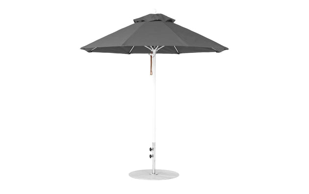 The Ledge Lounger Essential Fiberglass Umbrella features a tall, conical canopy made from marine-grade fabrics in gray, with a round metal base and central pole. Its design offers ample shade and wind resistance, highlighting the durability of the 7.5 Octagon Pulley against a plain white backdrop.