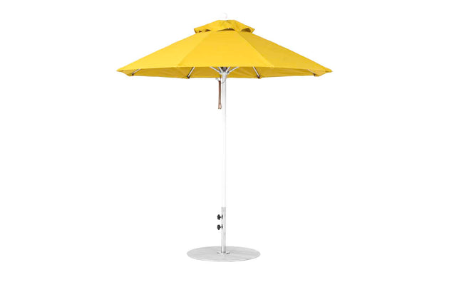The Ledge Lounger Essential Fiberglass Umbrella features a green octagonal canopy with a vent for airflow, a white pole, and a round base. Made from marine-grade fabric, its wind-resistant and perfect for outdoor settings against a plain white background.