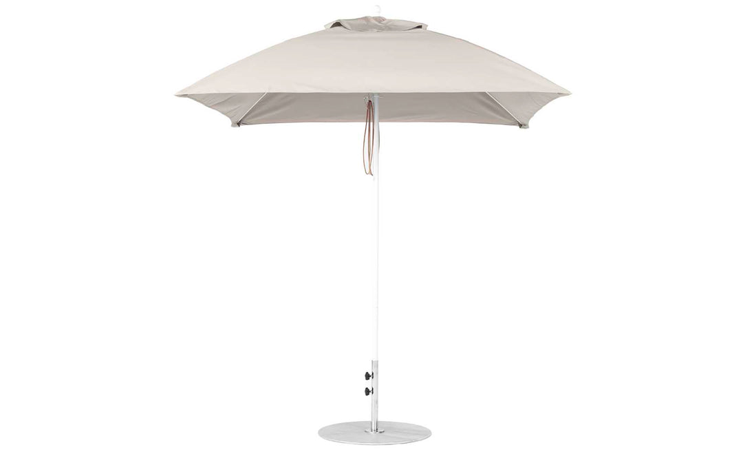 The Ledge Lounger Essential Fiberglass Umbrella - 7.5 features a round canopy crafted from marine-grade fabrics on a sleek metal pole with a circular base, equipped with a tie strap, and is showcased against a plain white background, emphasizing its durability akin to fiberglass umbrellas.