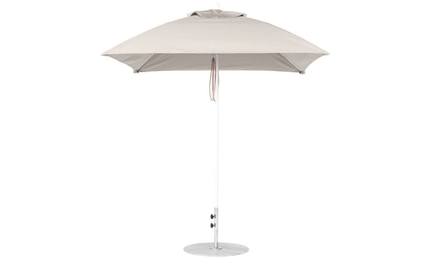 The Ledge Lounger Essential Fiberglass Umbrella - 7.5 features a round canopy crafted from marine-grade fabrics on a sleek metal pole with a circular base, equipped with a tie strap, and is showcased against a plain white background, emphasizing its durability akin to fiberglass umbrellas.