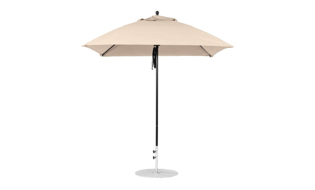 The Ledge Lounger Essential Fiberglass Umbrella, a 7.5 square pulley model in beige, features marine-grade fabrics on a silver pole with a circular base. Its robust design ensures durability and elegance, seen fully open against a plain white background.