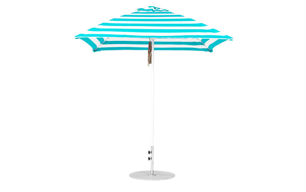 The Ledge Lounger Essential Fiberglass Umbrella features a blue and white stripe, marine-grade fabric, a pointed top with a straight metal pole, and stands securely on a round metallic base.