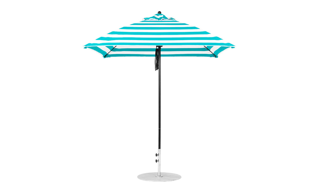 The Ledge Lounger Essential Fiberglass Umbrella, a 7.5 square pulley model in blue and white stripes, with a slim metal pole and round base, stands upright against a pristine white background.