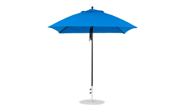 The Essential Fiberglass Umbrella by Ledge Lounger features a 7.5 square design with marine-grade fabric on a pointed top. Its sturdy metal pole rests on a round silver base, combining stylish durability for elegant outdoor shade.