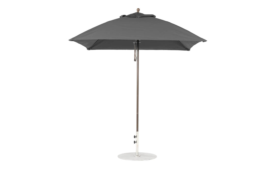 The Ledge Lounger Essential Fiberglass Umbrella - 7.5 Square Pulley is a gray outdoor umbrella featuring a sleek metal pole, smooth circular base, and a round canopy made from marine-grade fabrics, ensuring durability and style against its plain white background.