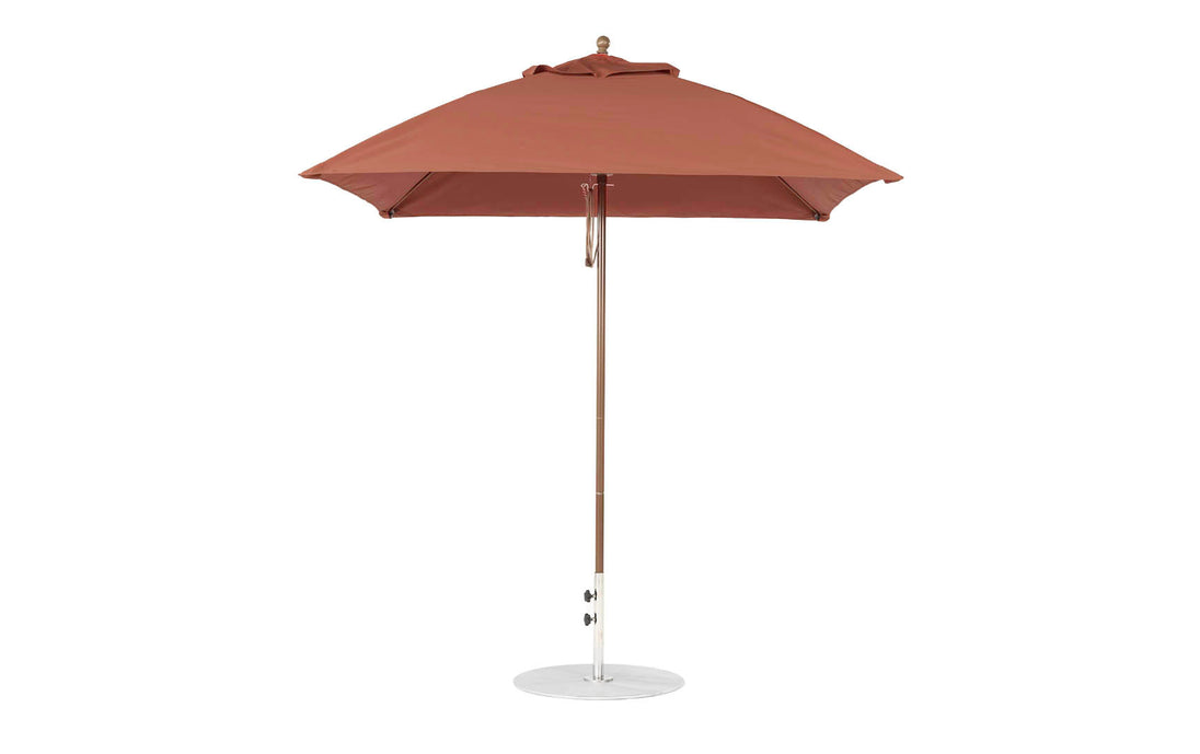 The Ledge Lounger Essential Fiberglass Umbrella, featuring a 7.5 square canopy in red with a straight pole, is open on a round metal base against a plain white background. Made from marine-grade fabrics, it offers durability and style for any garden setting.