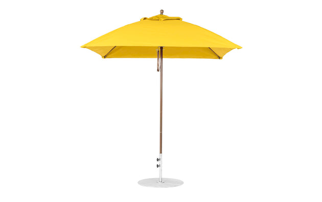 A yellow Essential Fiberglass Umbrella - 7.5 Square Pulley by Ledge Lounger features a marine-grade fabric canopy, thin silver pole, and circular base. The closed umbrella stands upright against a white background, highlighting its durable design.