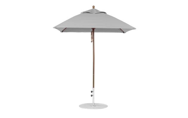 The Ledge Lounger Essential Fiberglass Umbrella - 6.5 Square Pulley features marine-grade fabric and an aluminum center pole, perfect for outdoor use. This large gray umbrella stands open with a circular base, making it ideal for providing shade in gardens or terraces.