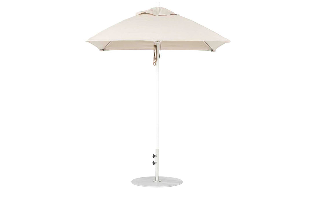The Ledge Lounger Essential Fiberglass Umbrella - 6.5 Square Pulley features a beige canopy with an aluminum center pole and round metal base. Its minimalist design enhances any outdoor space, while marine-grade fabrics guarantee durability in patios or gardens.