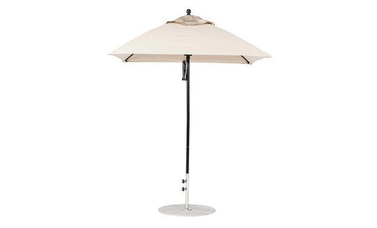 The Essential Fiberglass Umbrella - 6.5 Square Pulley by Ledge Lounger features a beige marine-grade fabric canopy on a black pole, wind-resistant design, and round metal base, making it ideal for outdoor use.
