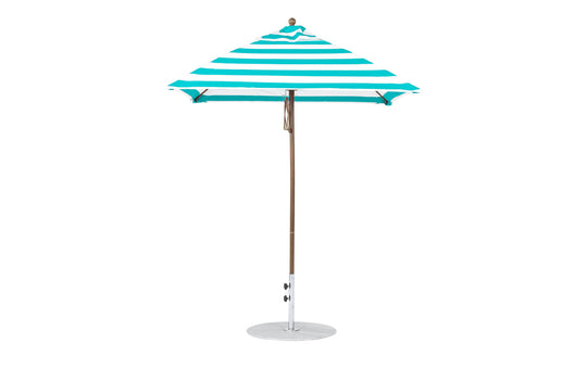 The Essential Fiberglass Umbrella by Ledge Lounger features green and white stripes with a sturdy metal pole and round base, against a plain white backdrop.