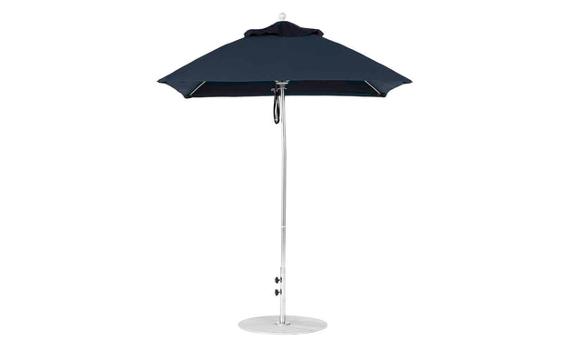 Against a white background, the open Ledge Lounger Essential Fiberglass Umbrella - 6.5 Square Pulley is displayed, featuring a navy blue marine-grade fabric canopy, an aluminum center pole, and a round base, providing ample shade.