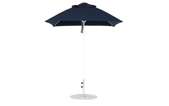 A modern Essential Fiberglass Umbrella by Ledge Lounger features a sleek conical black canopy, an aluminum center pole, and stands on a round base. It boasts durable marine-grade fabrics and a minimalist design.