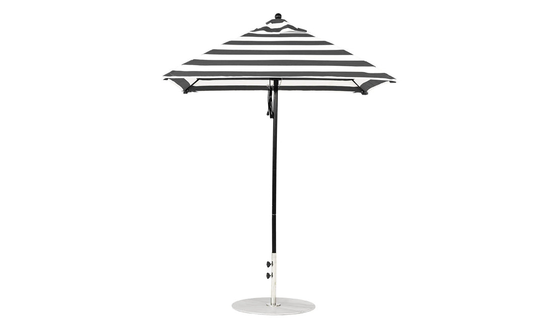 The Essential Fiberglass Umbrella - 6.5 Square Pulley by Ledge Lounger, featuring a durable aluminum pole and round silver base, stands upright against a plain white background with its elegant black and white stripes.