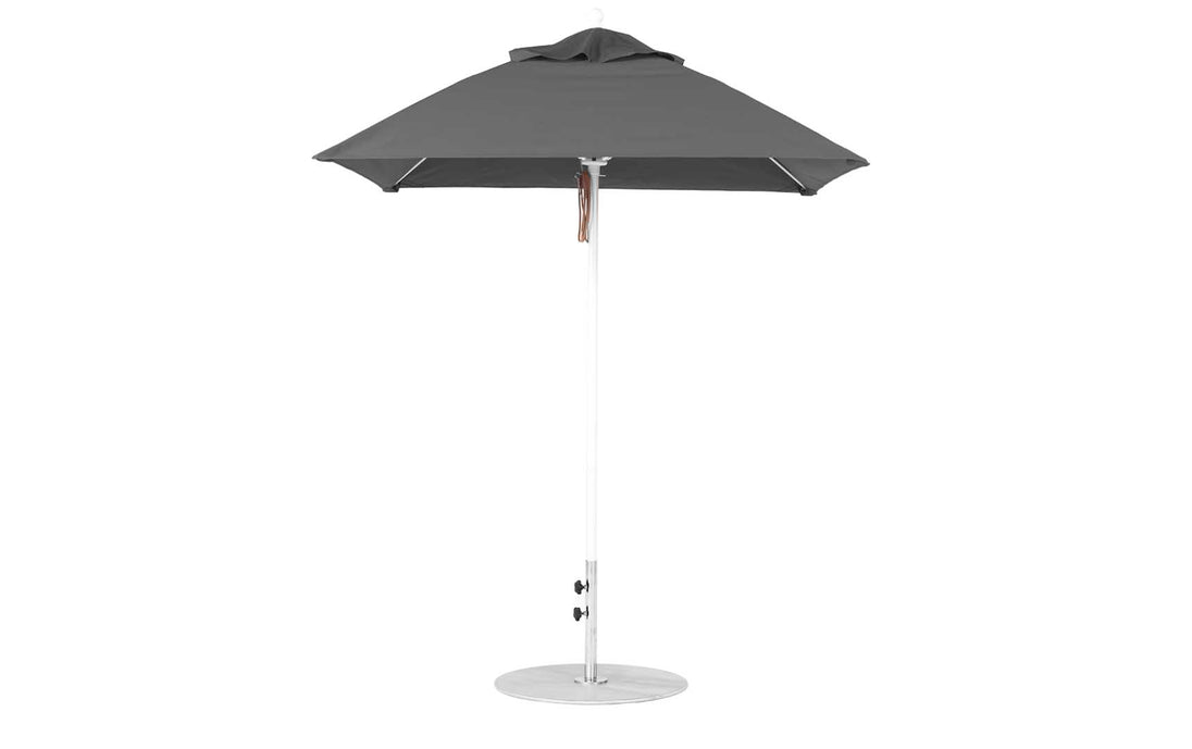 A Ledge Lounger Essential Fiberglass Umbrella - 6.5 Square Pulley in dark gray, with marine-grade fabrics and a round base, is elegantly displayed on a plain white backdrop.