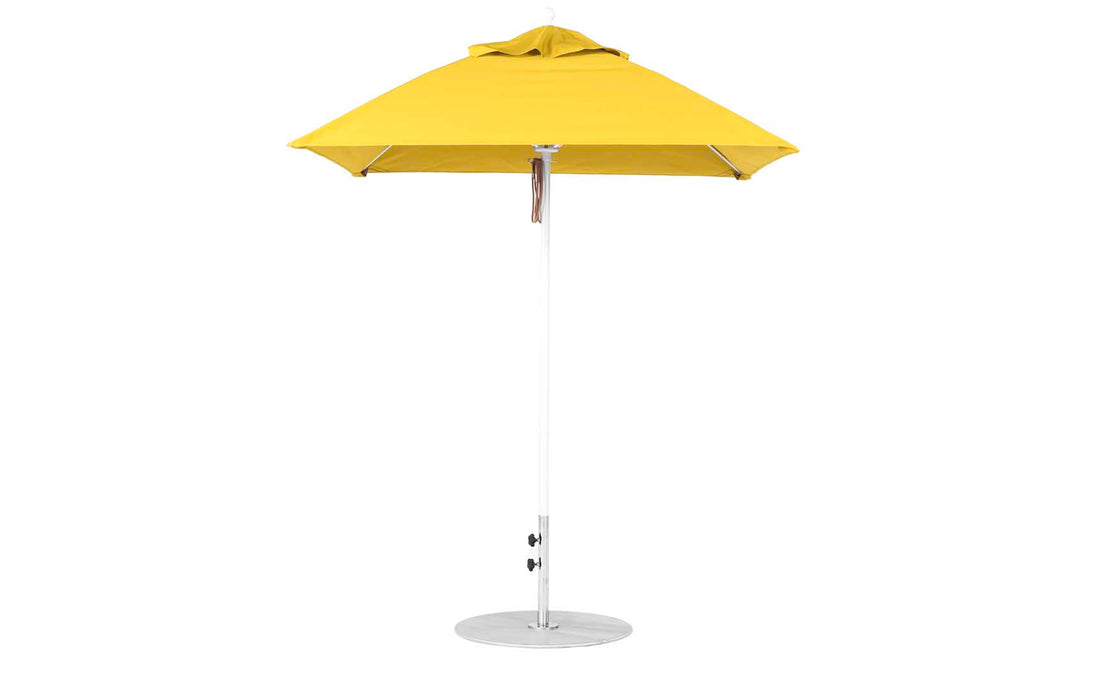The Ledge Lounger Essential Fiberglass Umbrella - 6.5 Square Pulley is a standalone yellow umbrella featuring an aluminum center pole and silver base. Its durable marine-grade fabrics ensure lasting quality, providing perfect shade for patios or gardens with its simple design.