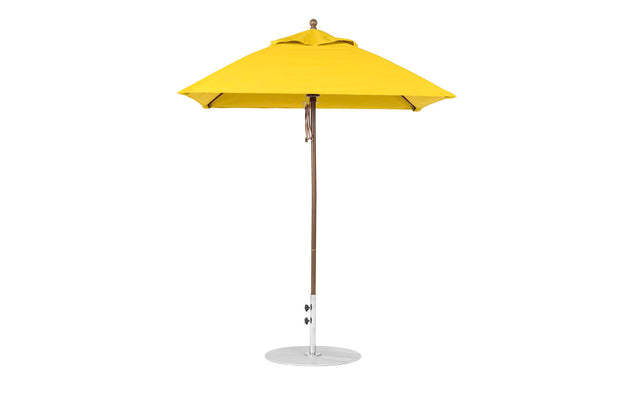 A yellow Essential Fiberglass Umbrella by Ledge Lounger, featuring a 6.5 square canopy and aluminum center pole with round base, stands upright against a white background.