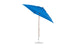 The Essential Fiberglass Umbrella by Ledge Lounger is a 7.5 square crank auto-tilt patio umbrella made from marine-grade fabrics, featuring a wooden pole and round metal base with a slight tilt.