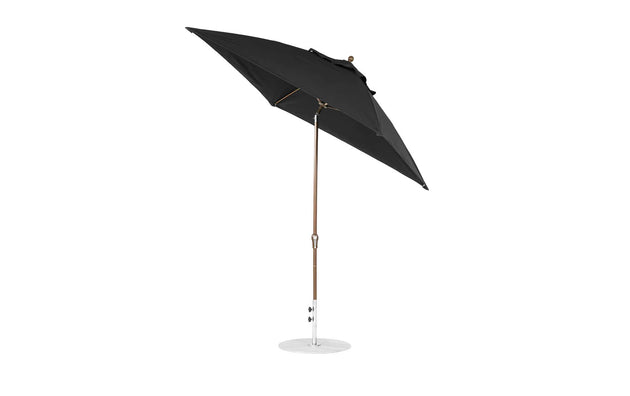 The Ledge Lounger 7.5 Square Crank Auto Tilt Essential Fiberglass Umbrella features a corrosion-resistant round white base, metal pole, and marine-grade fabrics. It is open and angled to showcase its sturdy structure against a plain white background.