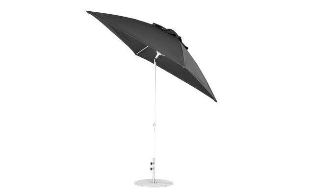 A black 7.5 Square Crank Auto Tilt Essential Fiberglass Umbrella by Ledge Lounger, featuring a silver pole and corrosion-resistant circular base, stands open and tilted against a plain white background.