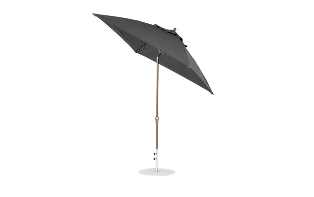 A black Ledge Lounger Essential Fiberglass Umbrella, 7.5 square with crank auto tilt, features a corrosion-resistant metal pole and round base on a white background, showcasing its tilted marine-grade fabric canopy for durability.