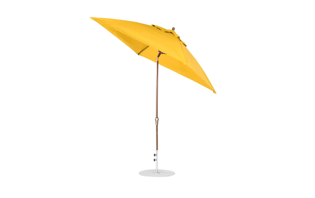 The Ledge Lounger Essential Fiberglass Umbrella - 7.5 Square Crank Auto Tilt is a yellow outdoor umbrella with a wooden pole and silver base, using marine-grade fabrics for durability and corrosion resistance, ideal for shading patios or gardens.