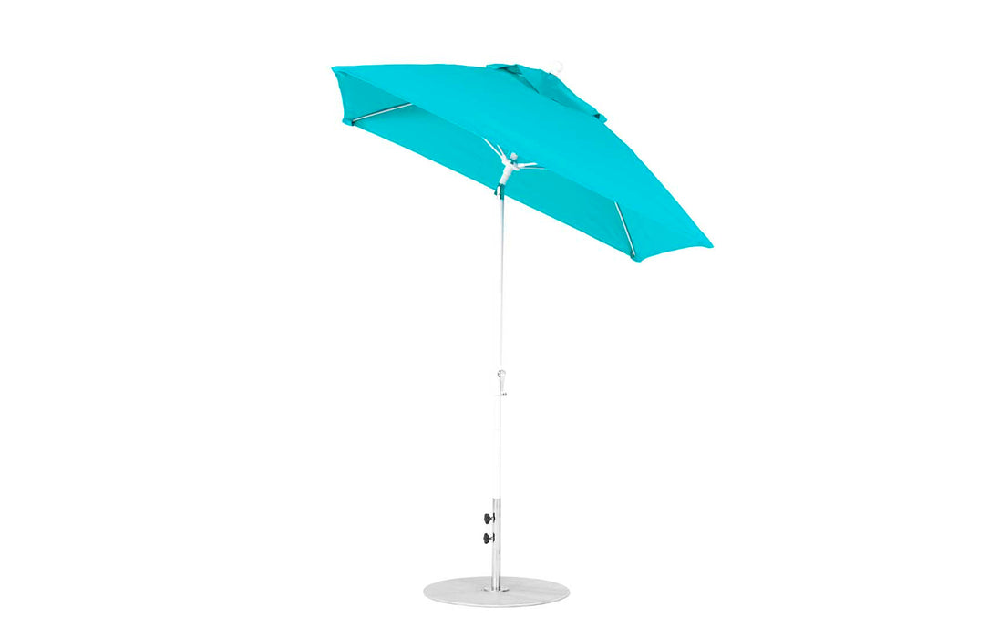 The Essential Fiberglass Umbrella by Ledge Lounger, a 6.5 square crank auto-tilt model, features a turquoise design with a silver pole and circular base against a white background. Made from marine-grade fabrics, it offers an adjustable and corrosion-resistant structure for lasting durability.