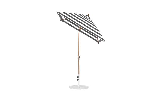 The Essential Fiberglass Umbrella by Ledge Lounger is a sleek, modern outdoor umbrella featuring marine-grade fabrics in black and white stripes. Its wooden pole and circular base ensure stability, while the 6.5 square crank auto-tilt design provides durable shading for outdoor settings.
