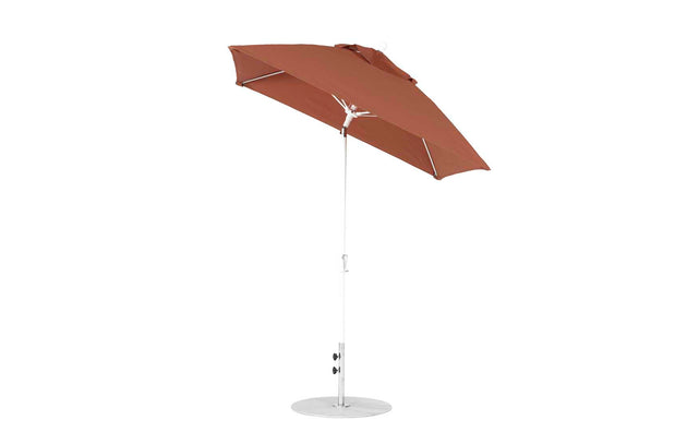 The Ledge Lounger Essential Fiberglass Umbrella features a corrosion-resistant metal pole with a round base and is crafted from marine-grade fabrics, slightly tilted to one side.