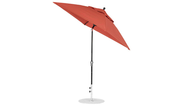 The Essential Fiberglass Umbrella by Ledge Lounger is a red 6.5 square outdoor umbrella with marine-grade fabric, a black metal pole, and round silver base. Its designed for corrosion resistance with an open, slightly tilted shape for enduring durability.
