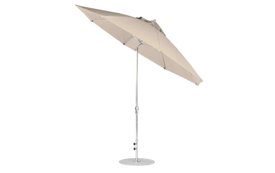 The Ledge Lounger Essential Fiberglass Umbrella - 11 Octagon Crank Auto Tilt has a beige marine-grade fabric canopy for durability and a silver aluminum pole with a slight angle for optimal shade, secured by its round base.