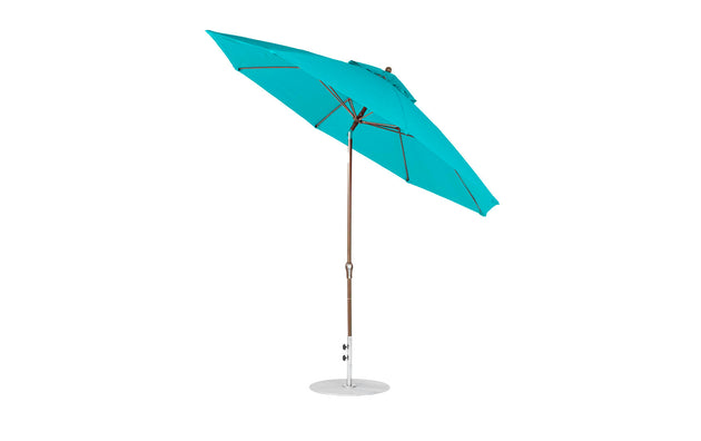 The Ledge Lounger Essential Fiberglass Umbrella features a teal marine-grade fabric, stylish wooden pole, and silver base, depicted on a white background.