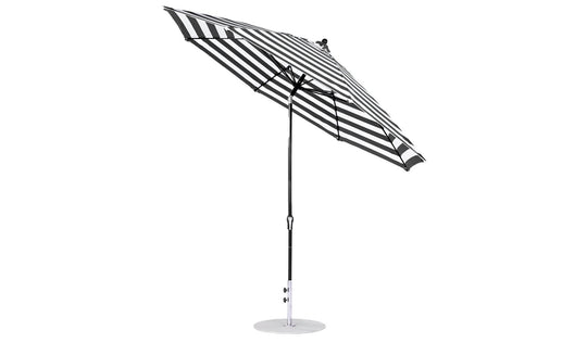 Tilted to show its underside, the Essential Fiberglass Umbrella by Ledge Lounger is an 11 octagon with a crank auto tilt, aluminum center pole, and circular base, featuring a black and white striped design perfect for modern outdoor spaces.