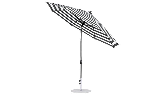 Tilted to show its underside, the Essential Fiberglass Umbrella by Ledge Lounger is an 11 octagon with a crank auto tilt, aluminum center pole, and circular base, featuring a black and white striped design perfect for modern outdoor spaces.