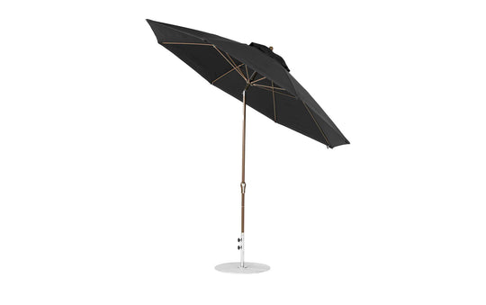 The Ledge Lounger Essential Fiberglass Umbrella features marine-grade fabrics and a brown pole, with an 11 octagon crank and auto tilt mechanism. It is black with a round base, partially tilted to the side to reveal its metal ribs.