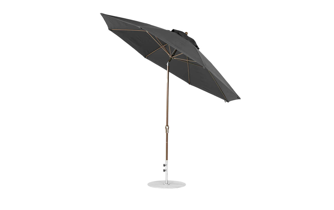 The black Essential Fiberglass Umbrella by Ledge Lounger features an 11 octagon canopy, crafted from marine-grade fabrics. It has a sleek aluminum center pole, circular base, and auto-tilt function for stylish shade in any outdoor setting.