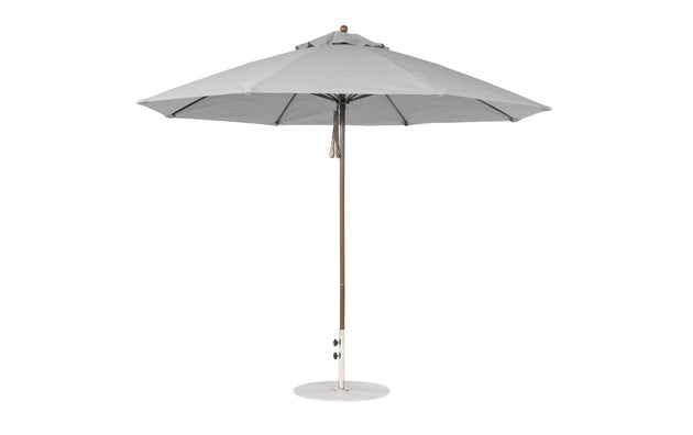 The Ledge Lounger Essential Fiberglass Umbrella - 11 Octagon Pulley features a round canopy with a central pole on a circular base. Made from marine-grade fabrics, this wind-resistant umbrella provides ample shade and its simple, modern design suits any outdoor setting.
