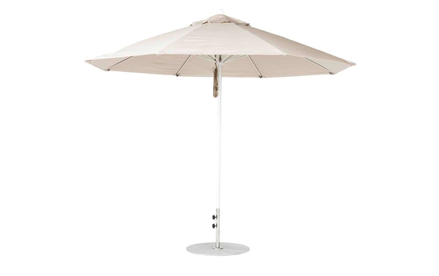 The Essential Fiberglass Umbrella - 11 Octagon Pulley by Ledge Lounger is a large beige outdoor umbrella featuring a sturdy metal pole and marine-grade fabrics, supported by metal ribs. Its round base ensures stability and wind-resistant durability, ideal for patio use.