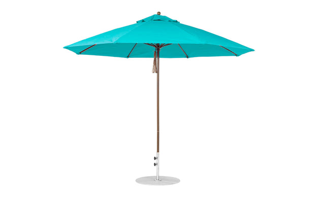 The turquoise Essential Fiberglass Umbrella by Ledge Lounger features an 11 octagon canopy and a wooden pole on a circular base. Its marine-grade fabric provides wind resistance, shade, and a vibrant pop of color for any outdoor space.