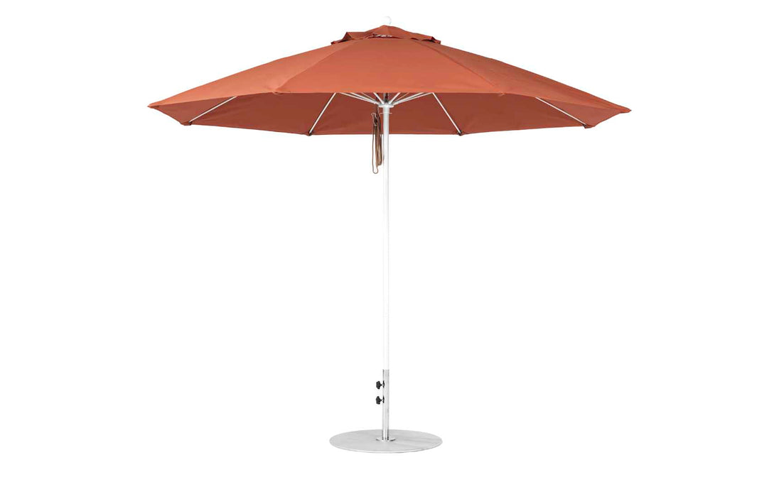 The Ledge Lounger Essential Fiberglass Umbrella features a rust-colored canopy made from marine-grade fabrics, an 11 octagon shape with a pulley system, a straight white pole, and sits on a circular flat base.