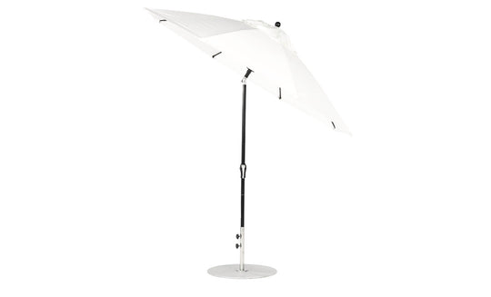 The Ledge Lounger Essential Fiberglass Umbrella features a 9 octagon canopy made of marine-grade fabrics, a black pole, and a round silver base. It stands open against a white background with an auto tilt crank mechanism for easy adjustment.