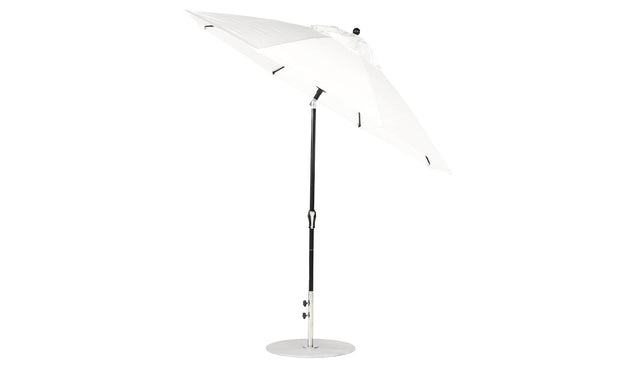The Ledge Lounger Essential Fiberglass Umbrella features a 9 octagon canopy made of marine-grade fabrics, a black pole, and a round silver base. It stands open against a white background with an auto tilt crank mechanism for easy adjustment.