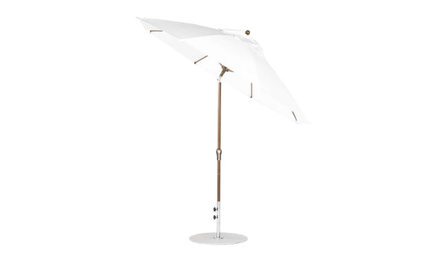 The Ledge Lounger Essential Fiberglass Umbrella features a 9 octagon canopy with crank auto tilt, durable wooden pole, and marine-grade fabrics, offering reliable shade and style for patios or gardens with its sleek design against a plain white backdrop.